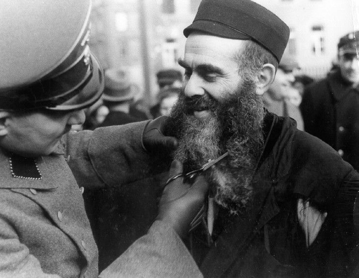 SS man cuts off a Jews beard in Poland